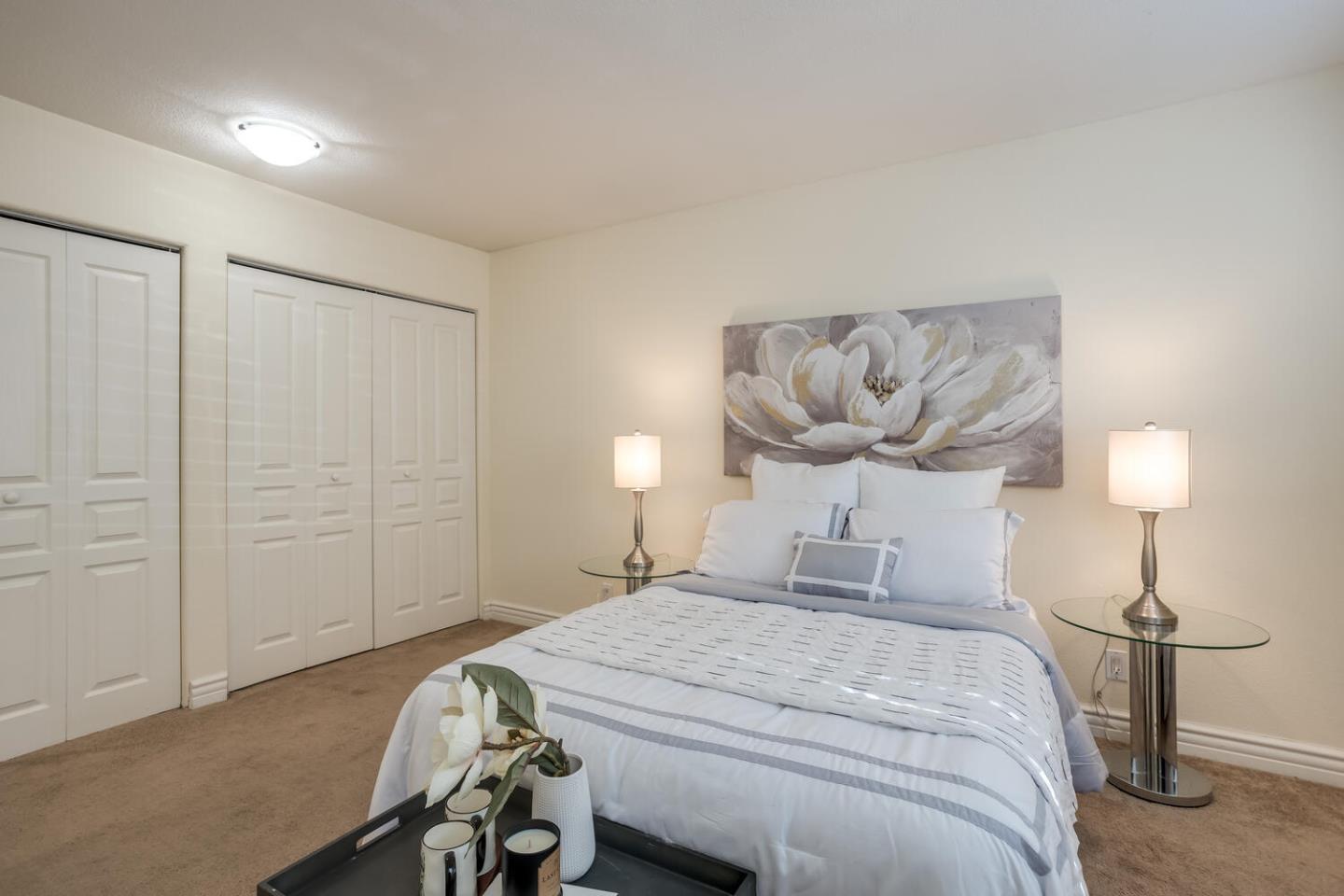 2580 Homestead Road, Unit 5101 Santa Clara, CA 95051 - Photo 18 of 33 a bedroom with a bed and a chandelier