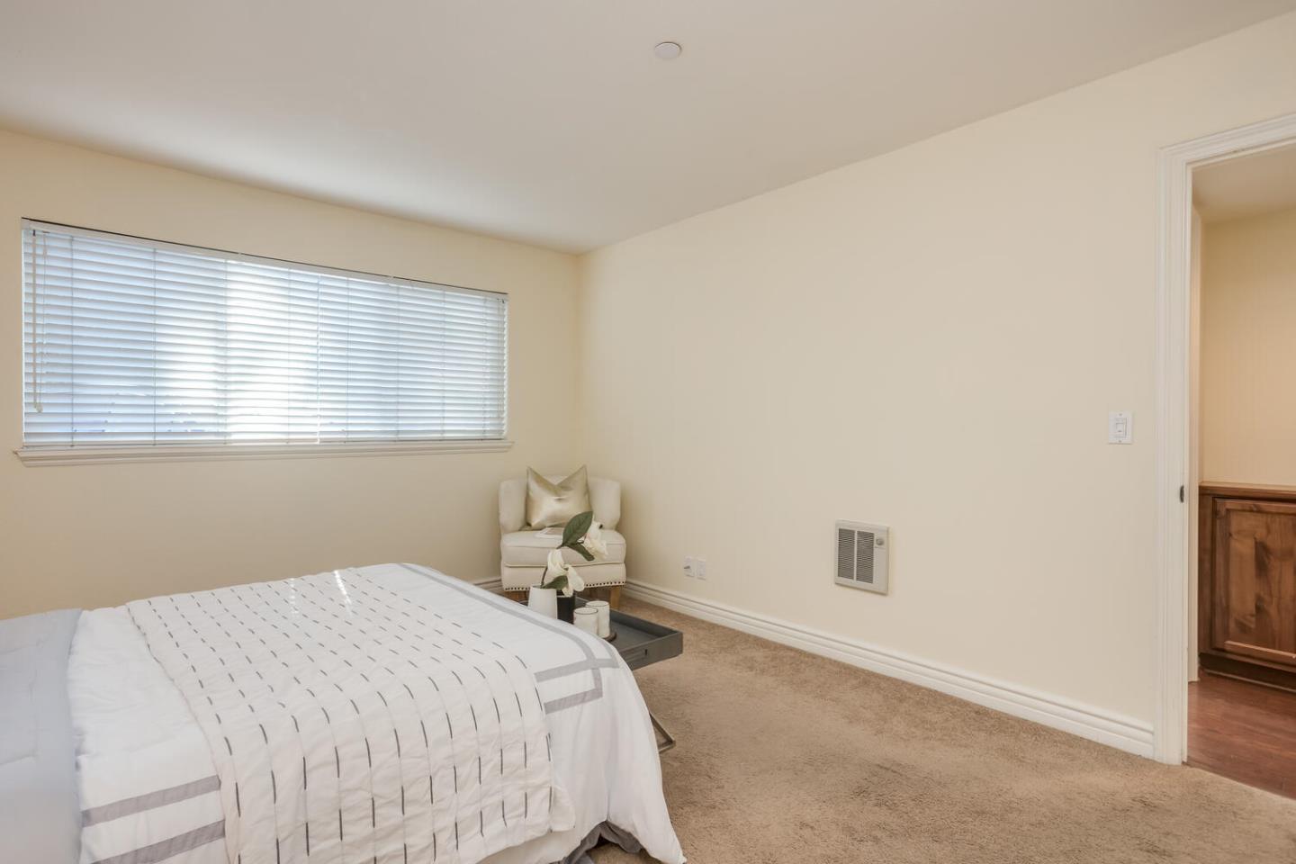 2580 Homestead Road, Unit 5101 Santa Clara, CA 95051 - Photo 20 of 33 a bed sitting in a bedroom next to a window