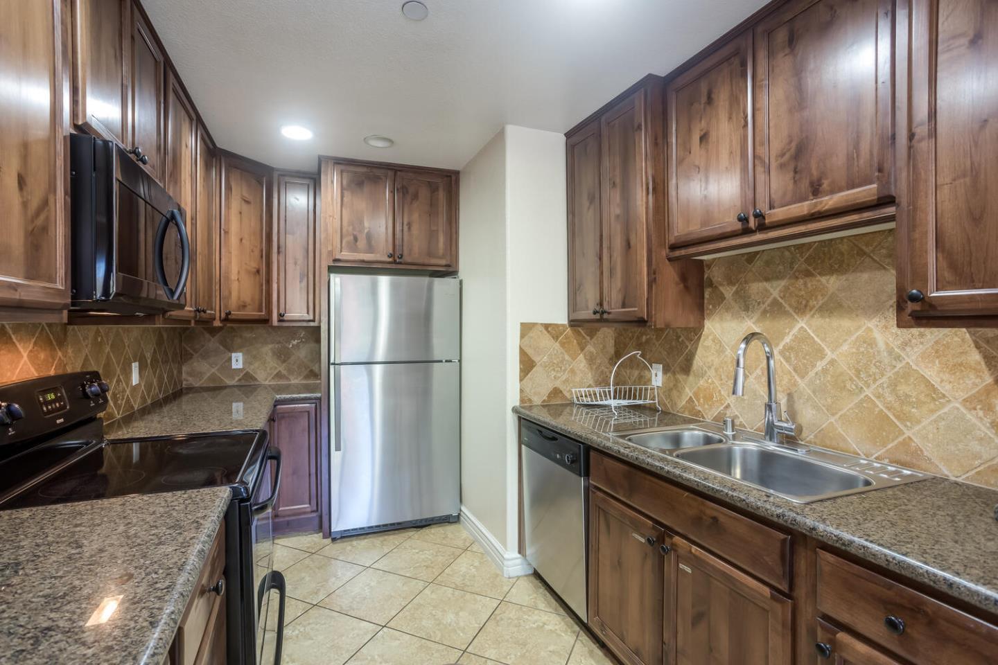 2580 Homestead Road, Unit 5101 Santa Clara, CA 95051 - Photo 10 of 33 a kitchen with stainless steel appliances granite countertop a sink a stove and a refrigerator