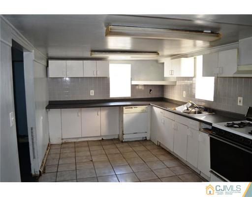 4 Brant Street South River, NJ 08882 - Photo 3 of 4 a kitchen with a sink stainless steel appliances and cabinets