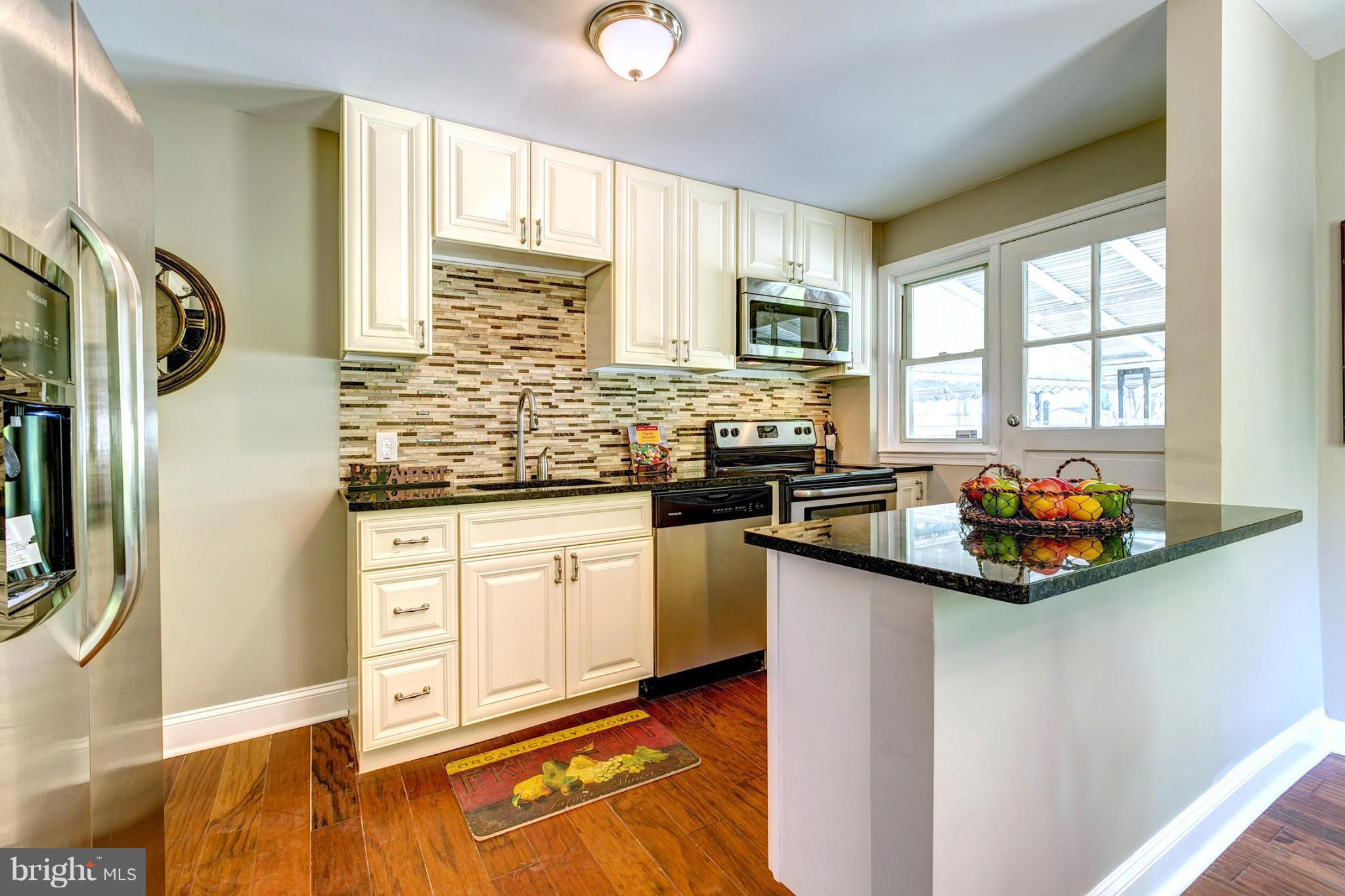 7412 Kirtley Road Baltimore, MD 21222 - Photo 11 of 30 Kitchen With Custom Tile Back Splash