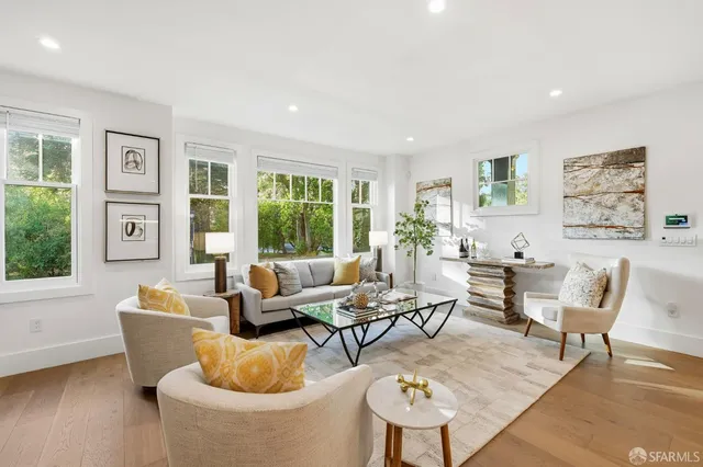 a living room with furniture a flat screen tv and a potted plant