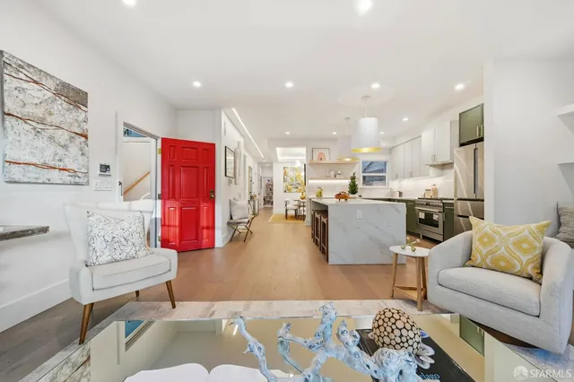 a large kitchen with a large counter top stainless steel appliances and cabinets
