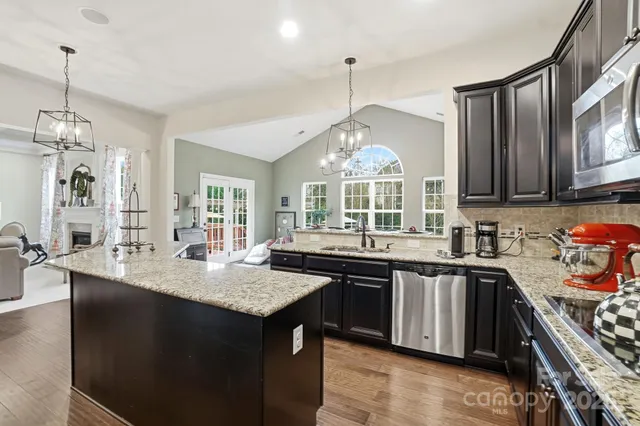 a kitchen with granite countertop a sink and cabinets