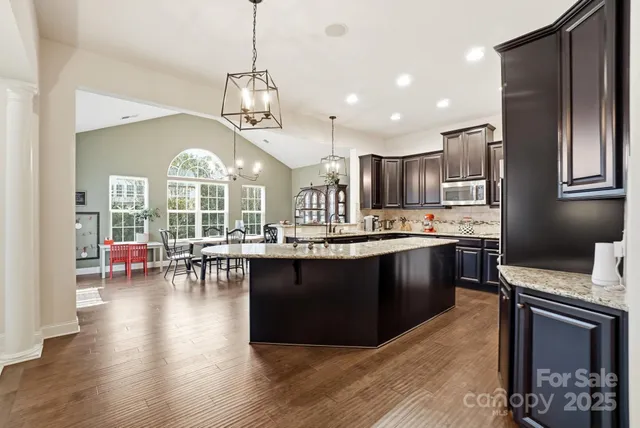 a large kitchen with a table and chairs
