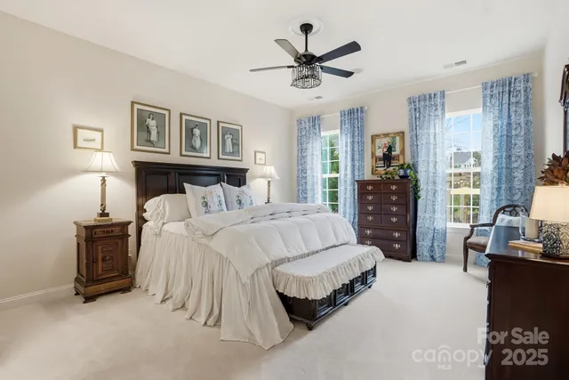a spacious bathroom with a tub and a large window