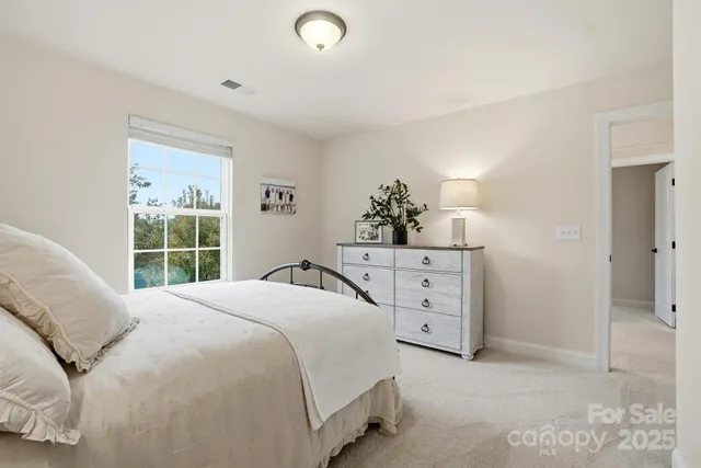 a view of a hallway with closet and a window