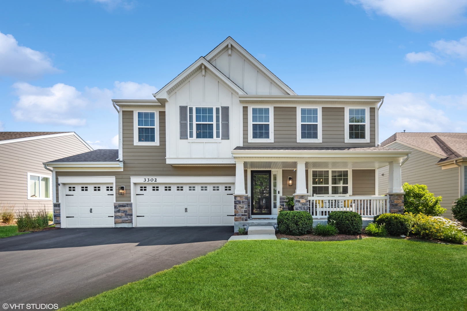 a front view of a house with a yard and garage