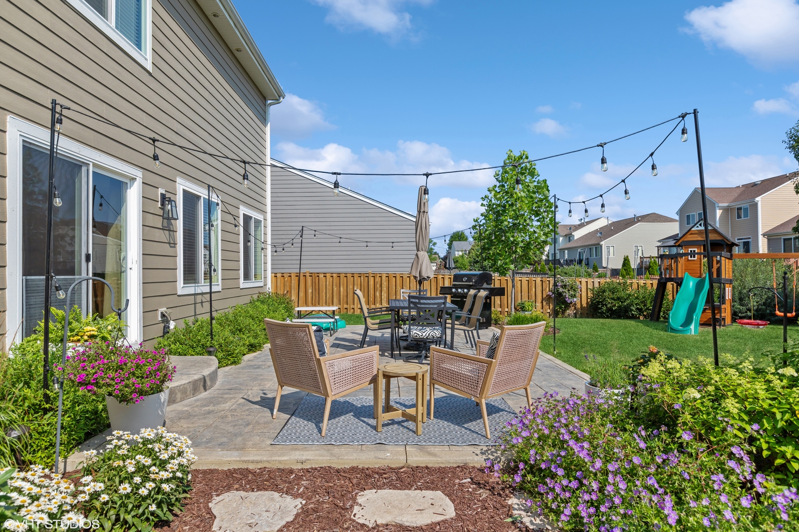 3302 Batley Street Elgin, IL 60124 - Photo 23 of 28 a view of a patio with table and chairs and potted plants