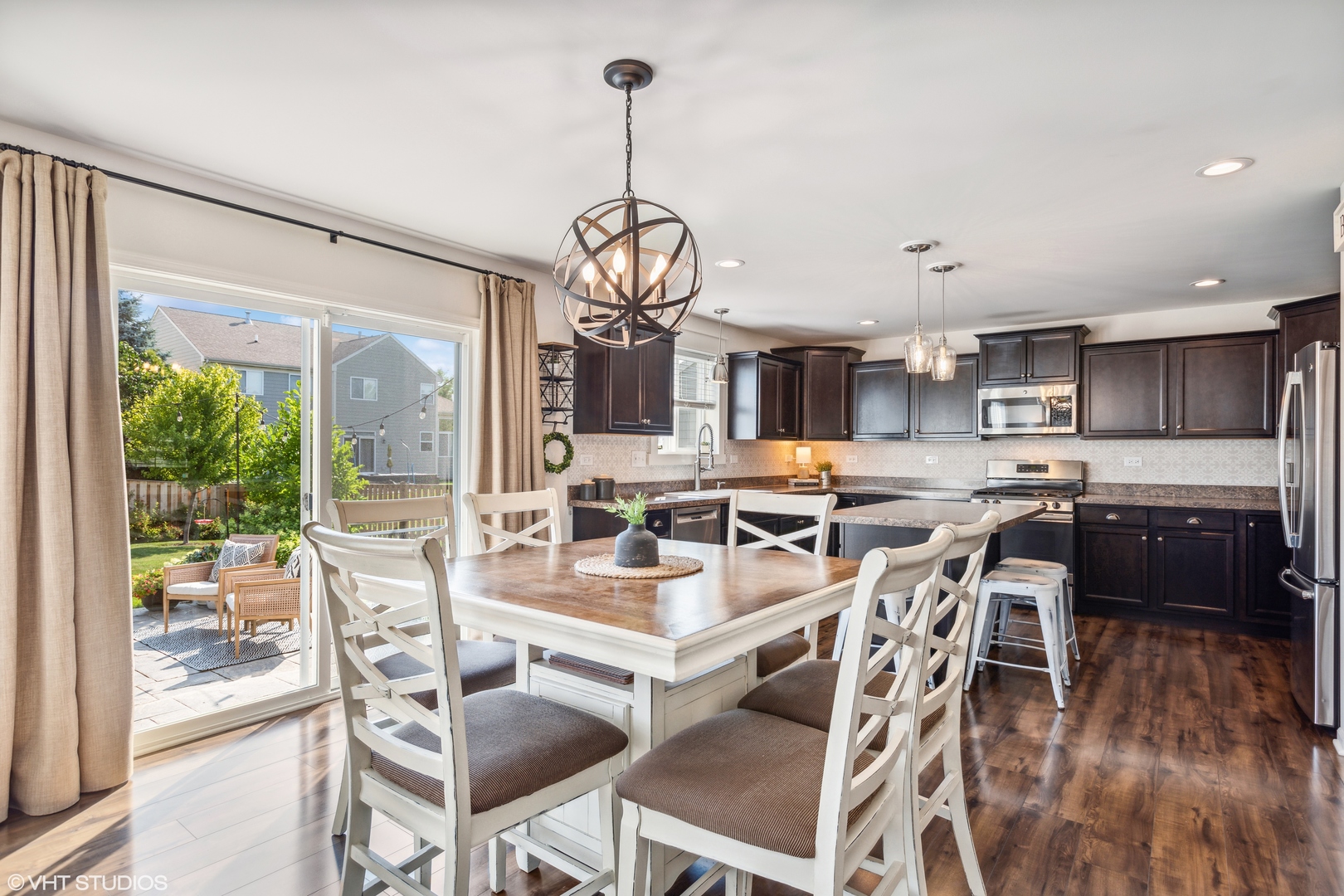 3302 Batley Street Elgin, IL 60124 - Photo 7 of 28 a view of a dining room with furniture large windows and wooden floor