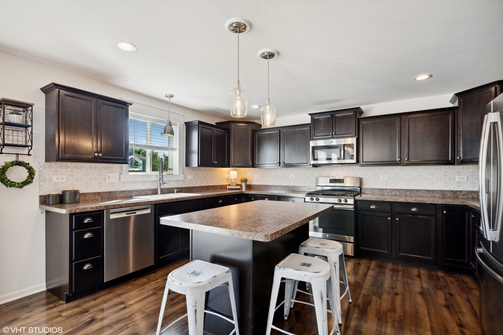 3302 Batley Street Elgin, IL 60124 - Photo 8 of 28 a kitchen with stainless steel appliances granite countertop a sink a stove a refrigerator cabinets and chairs
