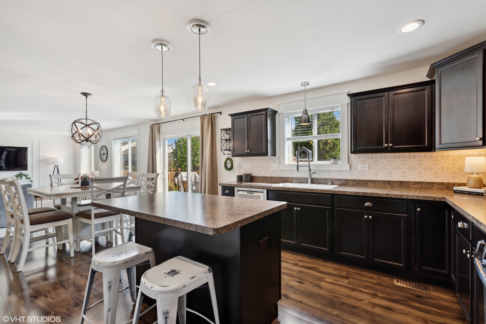 3302 Batley Street Elgin, IL 60124 - Photo 9 of 28 a large kitchen with lots of counter space dining table and stainless steel appliances