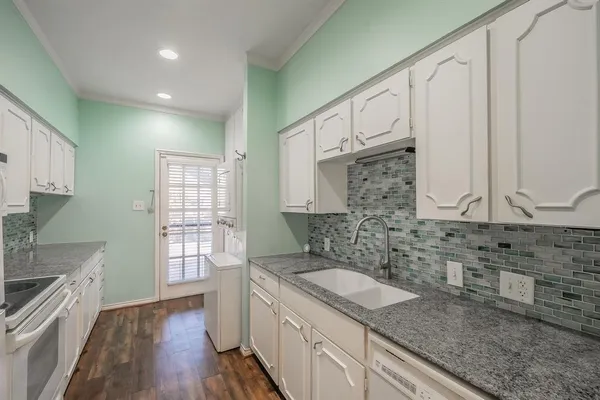 a kitchen with stainless steel appliances granite countertop a sink stove and cabinets