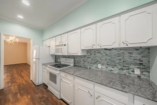 a kitchen with stainless steel appliances granite countertop a sink stove and cabinets