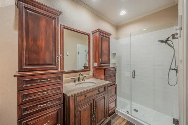 a bathroom with a double vanity sink mirror and shower