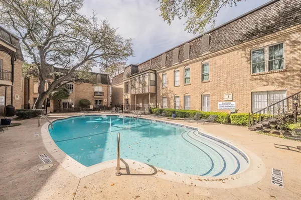 a swimming pool with outdoor seating and yard