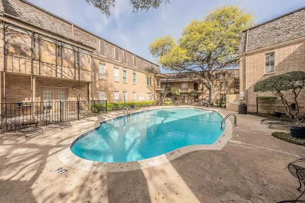 a view of a swimming pool with a patio