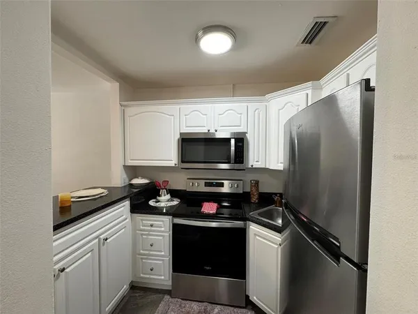 a kitchen with a stove and a refrigerator