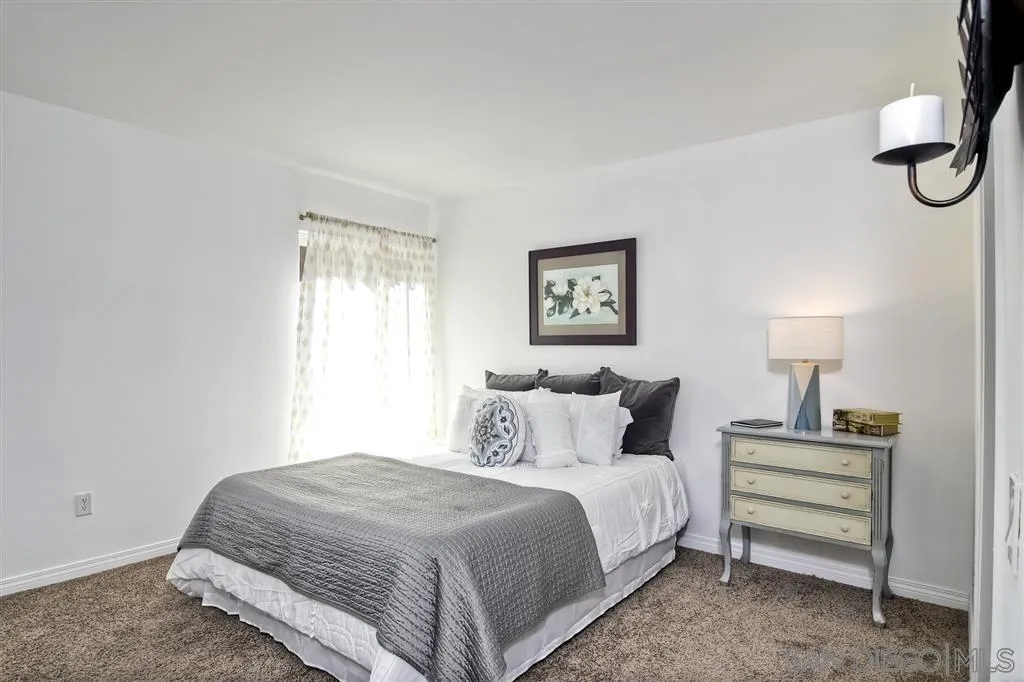 17119 West Bernardo Drive, Unit 108 San Diego, CA 92127 - Photo 14 of 18 a bedroom with a bed and a night stand