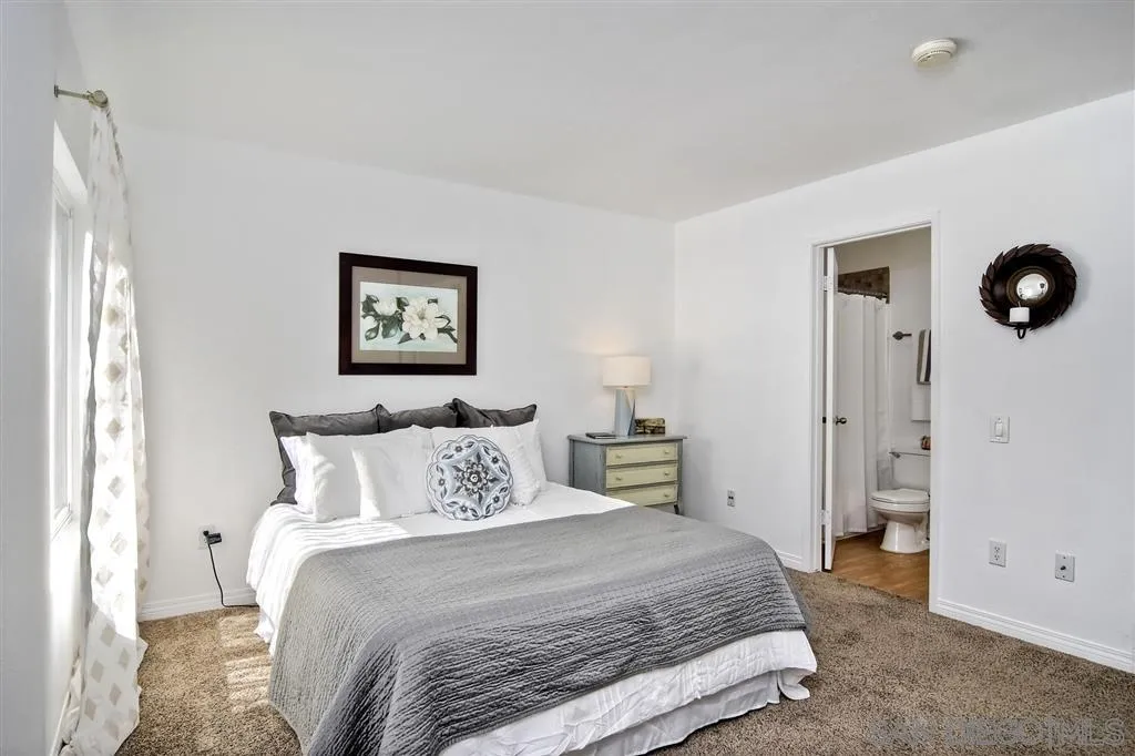 17119 West Bernardo Drive, Unit 108 San Diego, CA 92127 - Photo 15 of 18 a bedroom with a bed and cabinets