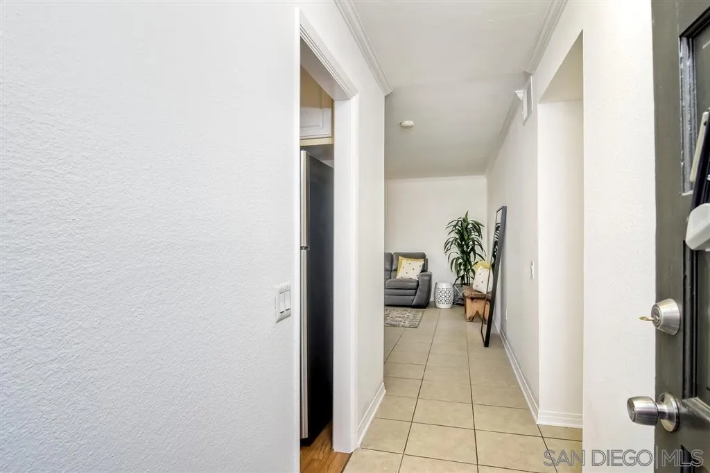 17119 West Bernardo Drive, Unit 108 San Diego, CA 92127 - Photo 7 of 18 a view of a hallway with a potted plant in front of a door