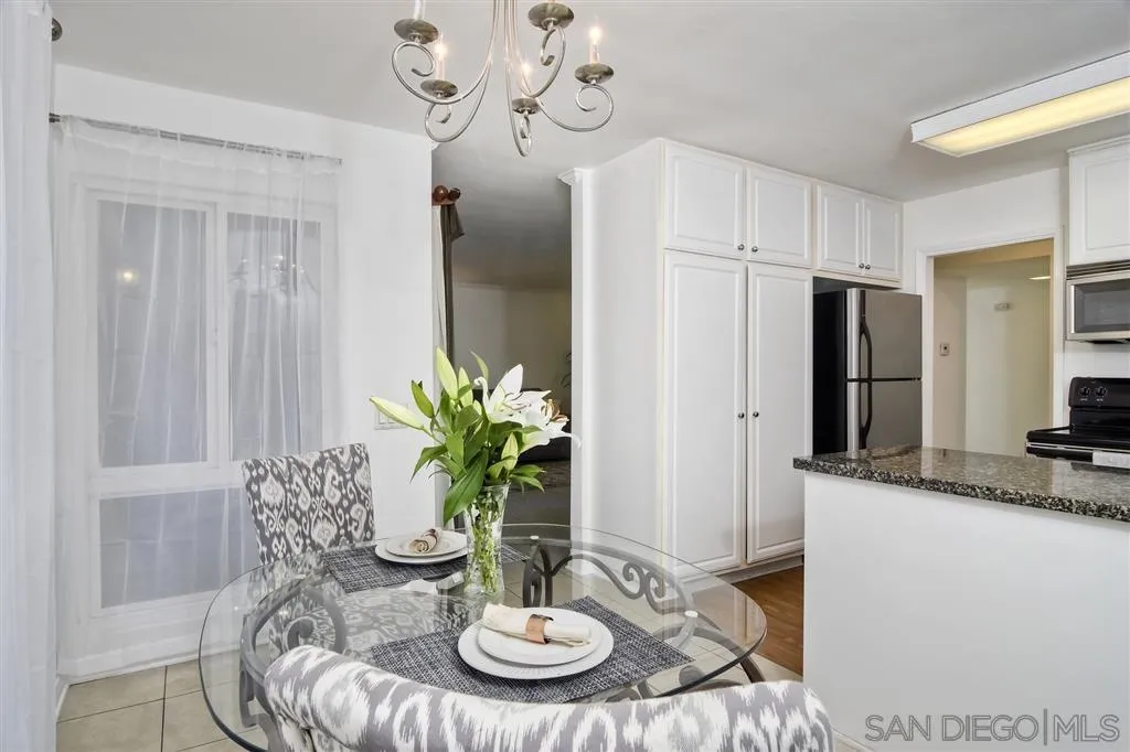 17119 West Bernardo Drive, Unit 108 San Diego, CA 92127 - Photo 9 of 18 a dining room with furniture and a chandelier