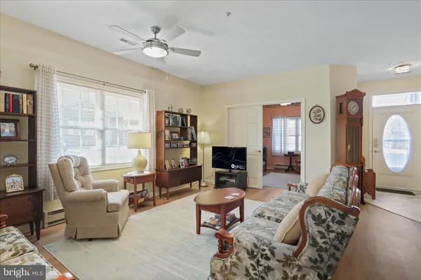 a living room with furniture a fireplace and a chandelier