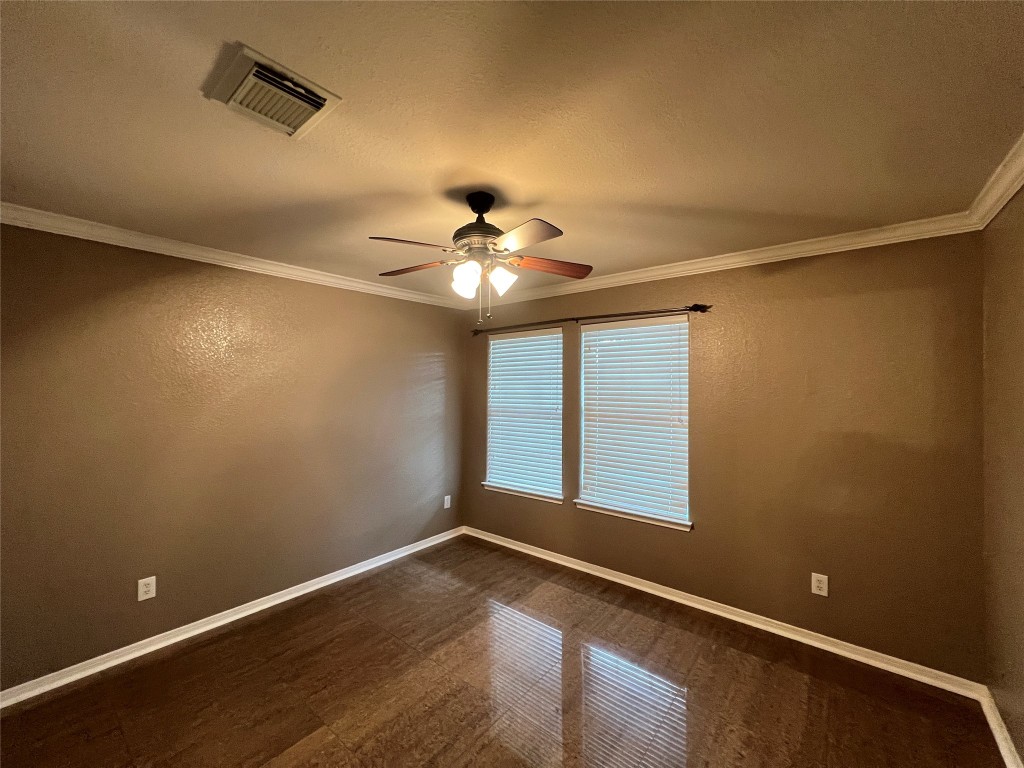 915 Wild Cotton Road Rosenberg, TX 77471 - Photo 24 of 38 a view of an empty room with wooden floor and a window