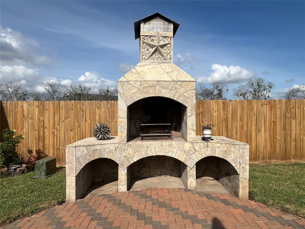 915 Wild Cotton Road Rosenberg, TX 77471 - Photo 33 of 38 a view of a livingroom with a fireplace a chandelier and windows