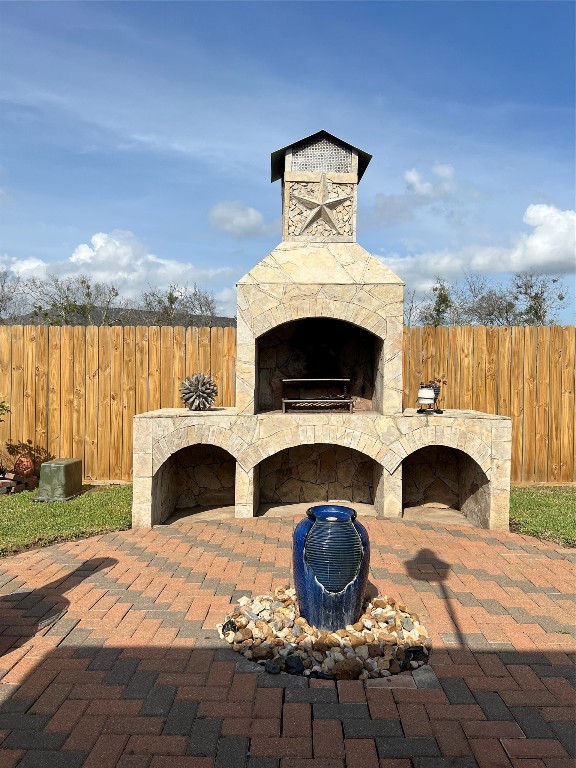 915 Wild Cotton Road Rosenberg, TX 77471 - Photo 34 of 38 a front view of a fireplace with crib and a garden