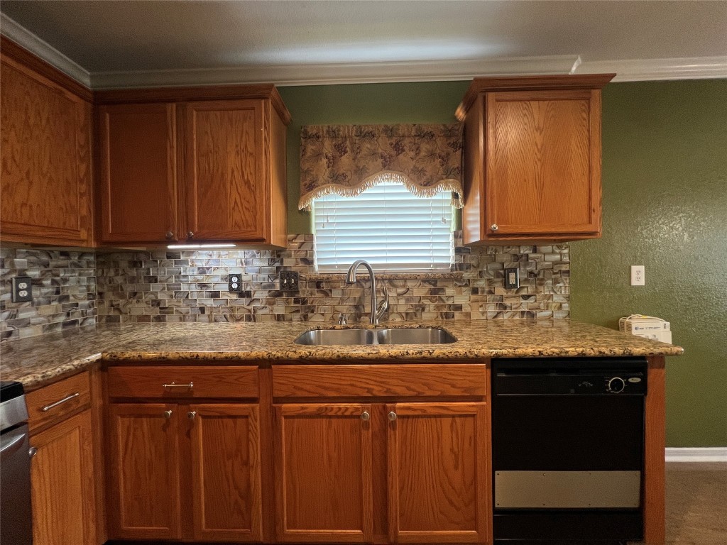 915 Wild Cotton Road Rosenberg, TX 77471 - Photo 8 of 38 a kitchen with granite countertop wood cabinets and a sink