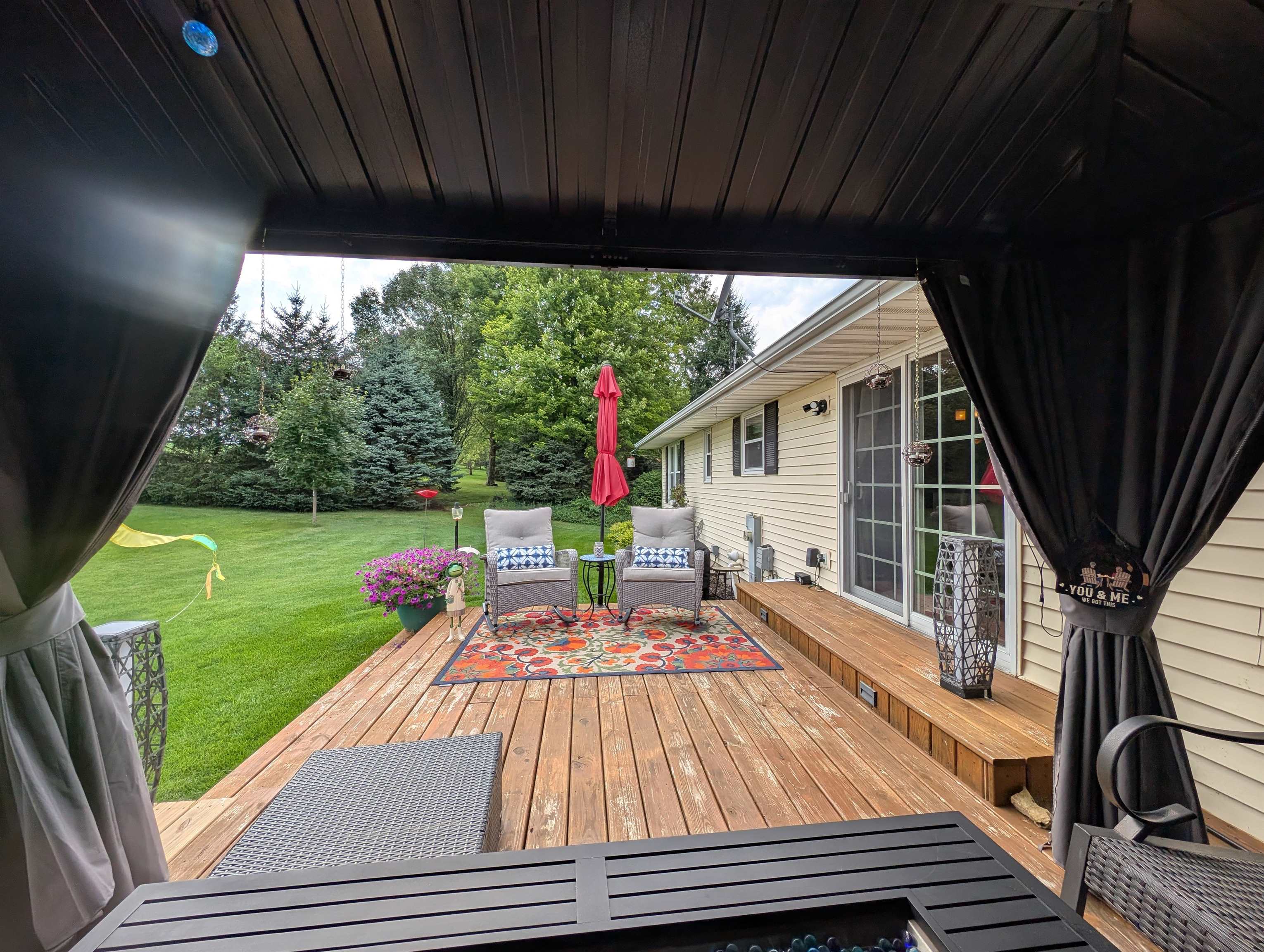 727 Westmore Road Davis, IL 61019 - Photo 20 of 32 a view of a deck with a table chairs and a yard
