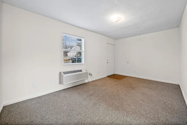 an empty room with a empty space and windows