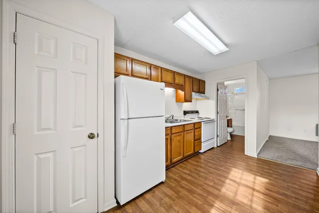 a kitchen with refrigerator a microwave and stove