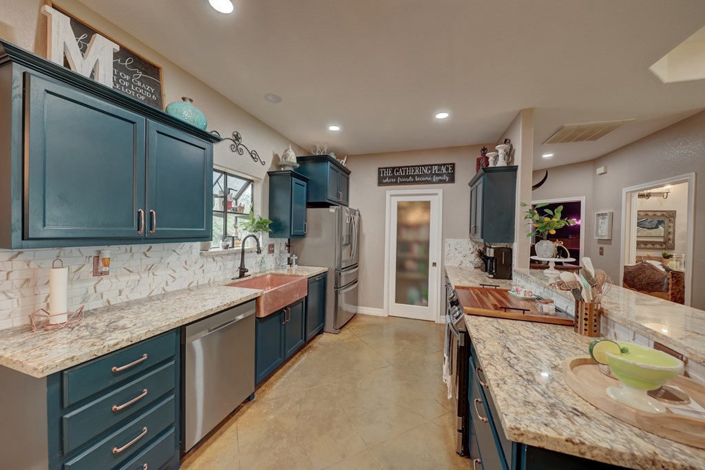 8177 Wendel Road Harper, TX 78631 - Photo 8 of 32 a large kitchen with kitchen island a sink stainless steel appliances and cabinets