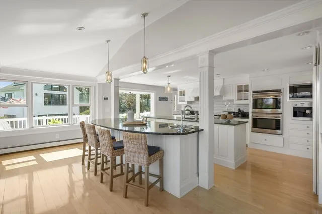 a kitchen with cabinets a sink and wooden floor