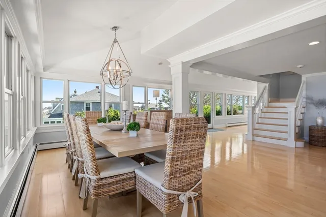 a dining room with furniture a chandelier and wooden floor