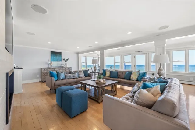 a large living room with furniture and floor to ceiling window