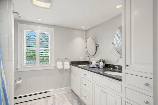 a large bed sitting in a bedroom next to a window with a bookshelf