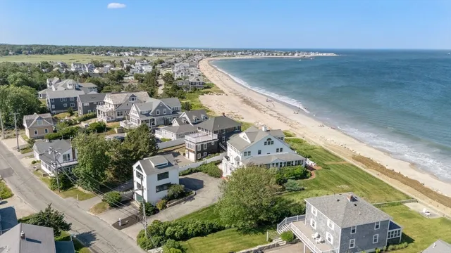 a view of a patio with furniture and a garden