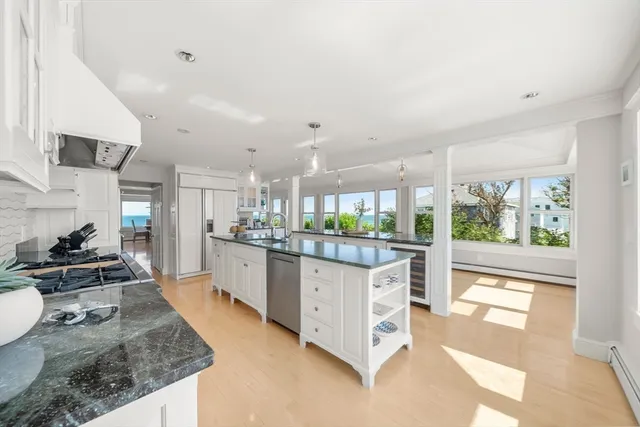 a large kitchen with kitchen island a large counter space a sink and stainless steel appliances