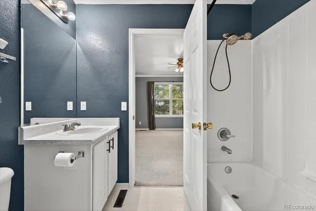 a bathroom with a sink a vanity and shower