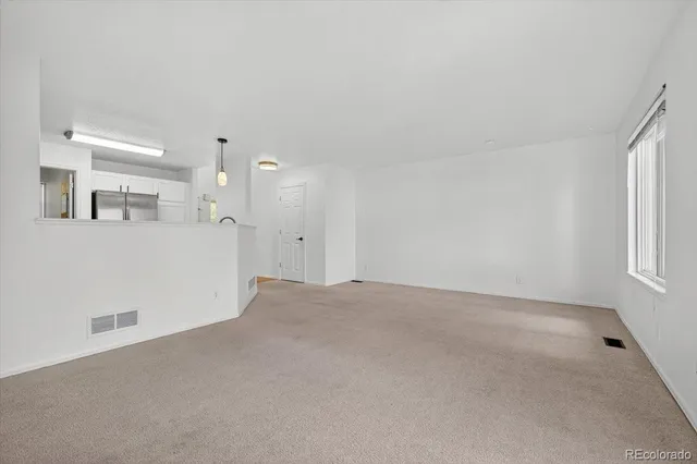 a view of an empty room with a window