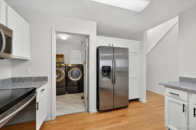 a kitchen with stainless steel appliances granite countertop a refrigerator and a stove top oven
