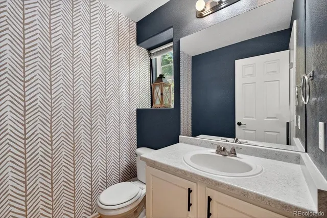 a bathroom with a sink a toilet and mirror