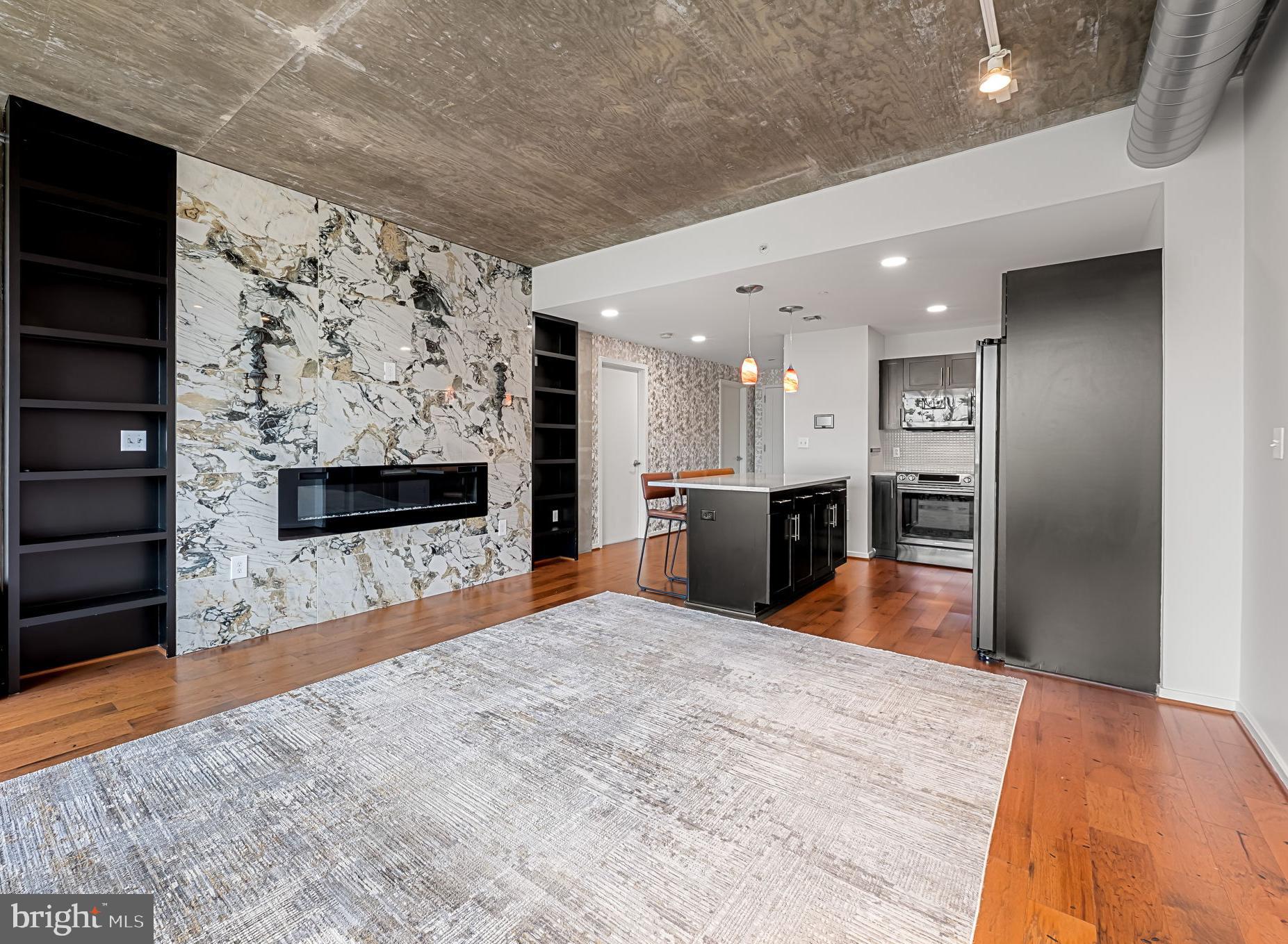 1200 Steuart Street, Unit 425 Baltimore, MD 21230 - Photo 8 of 33 Custom linear electric fireplace with bookshelves