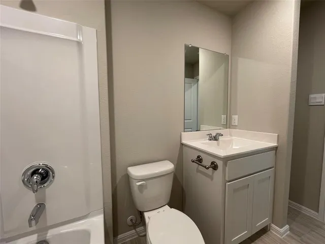 a bathroom with a sink toilet and mirror