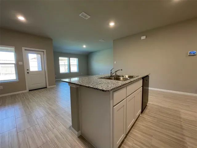 a kitchen with sink and cabinets