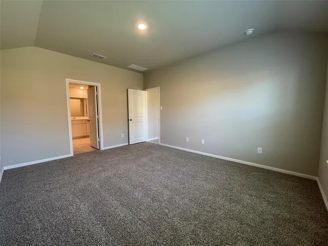 an empty room with closet and windows