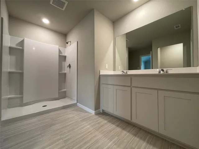 a bathroom with a sink and mirror